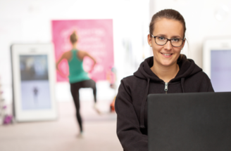 Fitnesstrainerin und Mitglied am digitalen Smarttrainer beim funktionellen Training in einem Mrs.Sporty Club